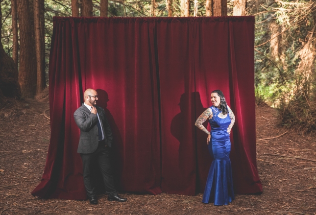 Couple standing by curtain outside